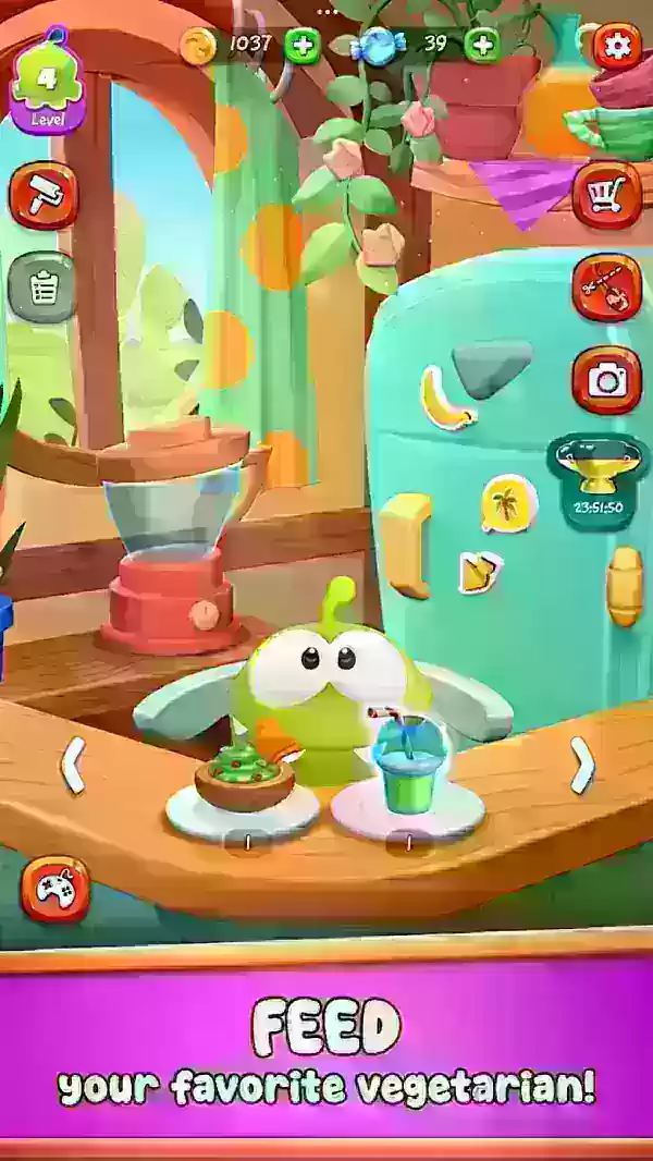 A cute green creature sits in a high-chair being feed snacks.